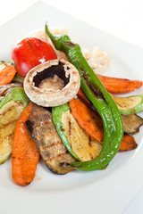 Meat steaks garnished with vegetables