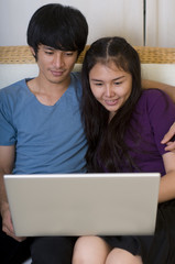 Young Asian couple with computer