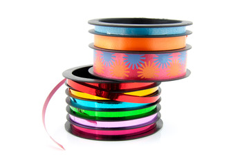 colorful streamers on a role over white background