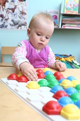 The little girl collects chesspieces