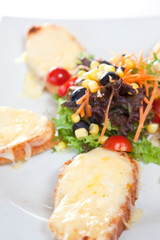 Colorful salad with cheese bread slices