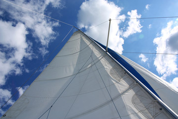 Yacht sail mast with white cloudless and blue sky