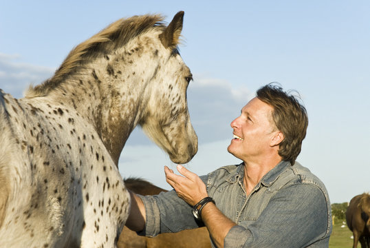 happy man petting his horse