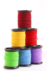 Coloured bobbins of thread isolated on white