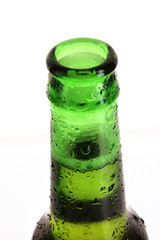 Green glass bottle with beer isolated on white