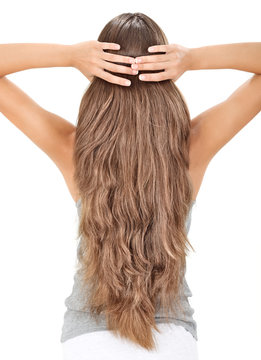 Brunette lady holding long hairs, view from back side isolated o