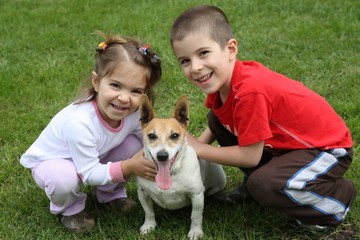 Obraz premium Two cute happy kids with dog
