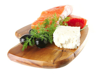 smoked salmon on wooden plate with white cheese
