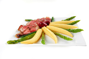 meat served on white with corns