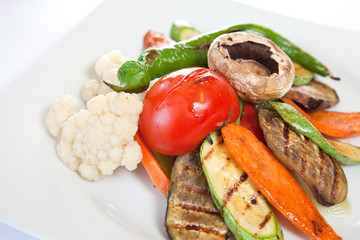 Meat steaks garnished with vegetables