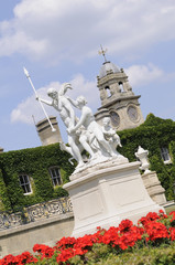 red flowers in front of Venus and  Adonis statues