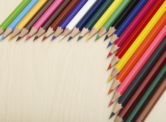 Fototapeta premium Close up of colored pencils on wooden desk