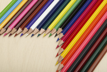 Close up of colored pencils on wooden desk