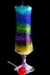 Mixing a colourful cocktail, lit from behind