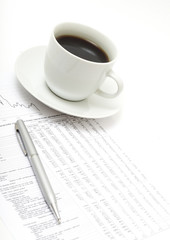 White cup of cappuccino on paper table numbers.