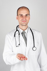 Young doctor offering pill