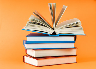 Stack of books on the color background