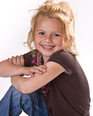 Close up of cute little girl with her arms crossed