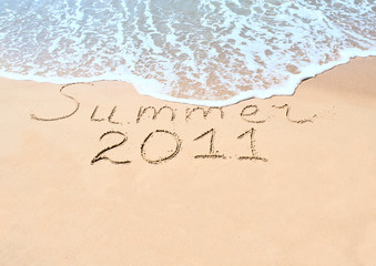 Inscription on wet sand "Summer 2011"