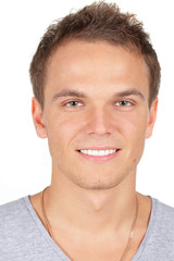 Obraz premium Handsome young man smiling. Isolated on white.