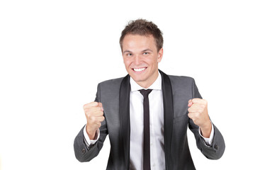 One happy energetic businessman with his arms raised.