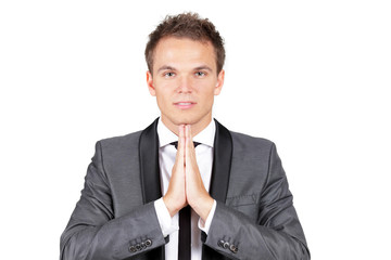 A trendy caucasian businessman making a prayer