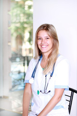 A pretty young woman nurse inside hospital building