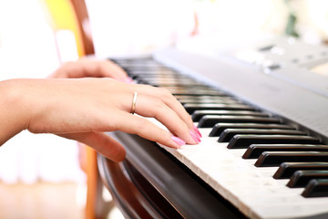 Fototapeta premium woman playing on electric piano