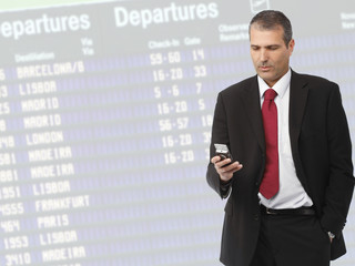 businessman calling on mobile phone on airport