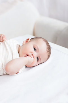 Portrait of a cute baby lying on table in the living-room