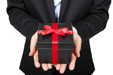 businessman holding a gift package in hand .