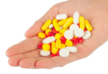 Pills in a hand on white background