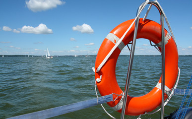 red lifebuoy on yacht , background made from lake