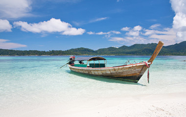 longtail boat and beautiful beach with white sand