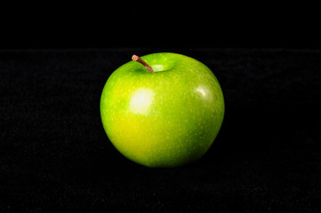 Green apple isolated, black background