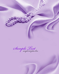 Pearls a necklace on a silk fabric