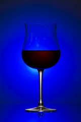Still-life with the wine glass on blue