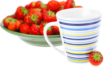 cup and saucer with strawberries isolated on white