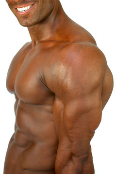 Smiling man showing muscular body on a white background