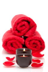 Fototapeta na wymiar Spa candles, towels, rose petals