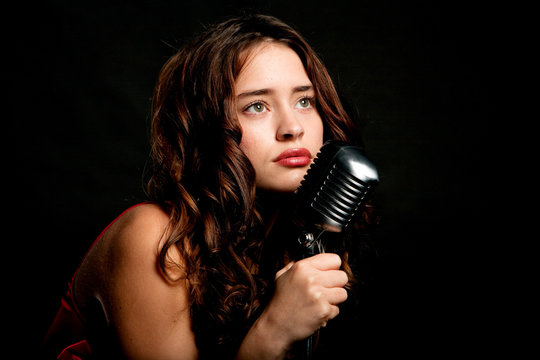Beautiful singer singing with microphone