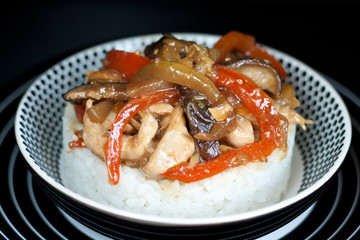 Asian rice topped with chicken,  vegetables and Shitaki