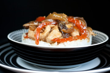 Asian rice topped with chicken,  vegetables and Shitaki