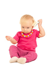 cute adorable baby play with comb on white