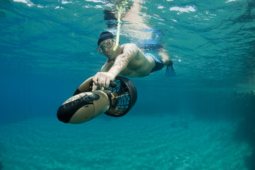 snorkeler on underwater scooter