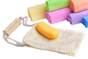 Sponge, soap and towels on a white background..