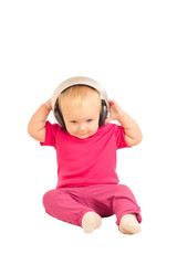 young cheerful baby listening to the music in headphones