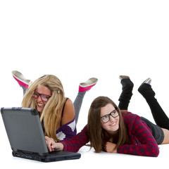 Two young teenagers with a laptop.