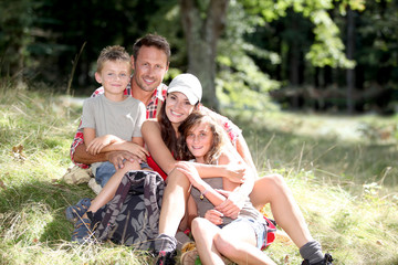 Family sitting in nature on a hiking day