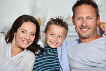 Fototapeta premium Closeup of parents and child relaxing at home on sofa